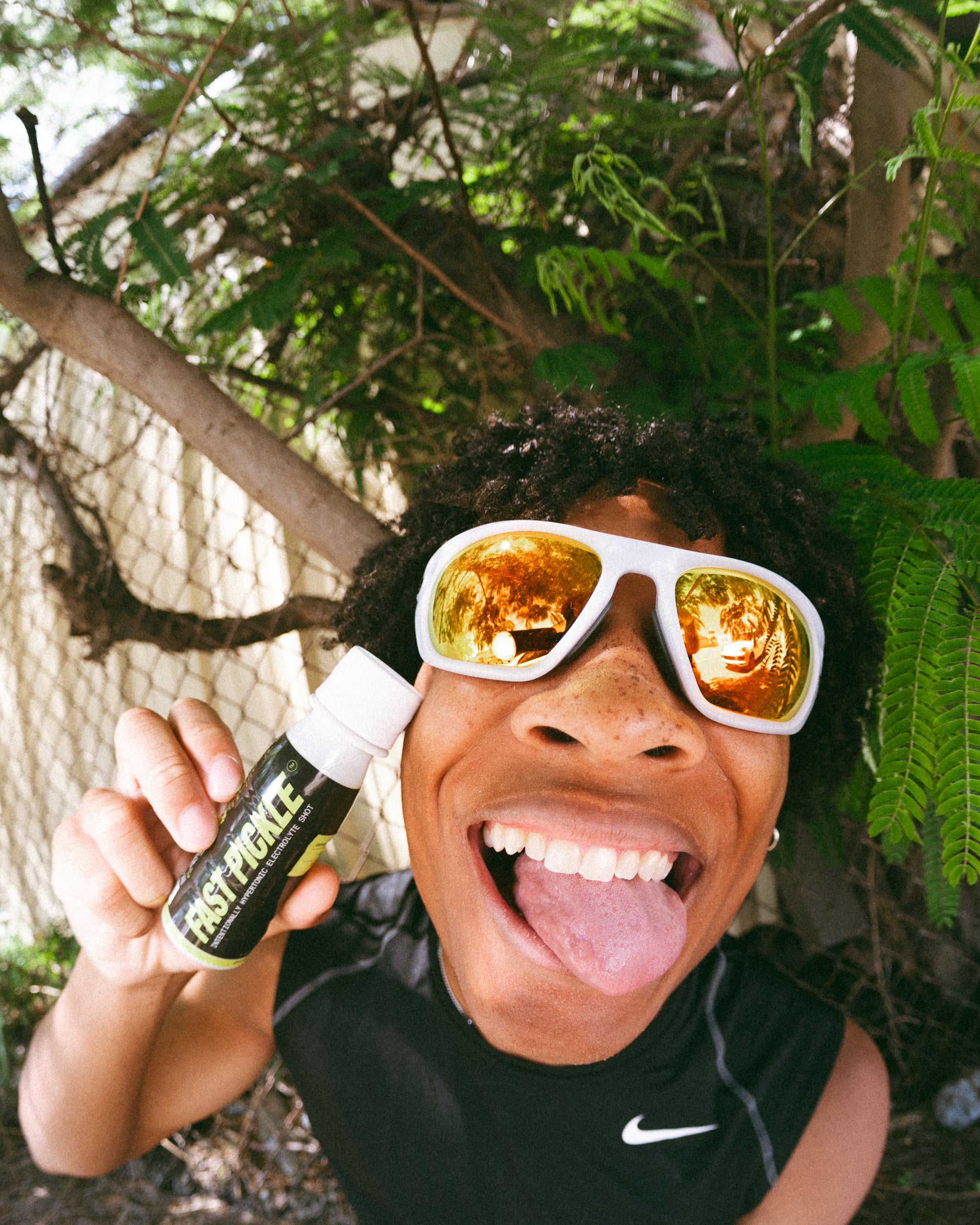 A Fast Pickle athlete reacts after a brine shot — the same sour-salty face a chamoy pickle produces, minus the candy.